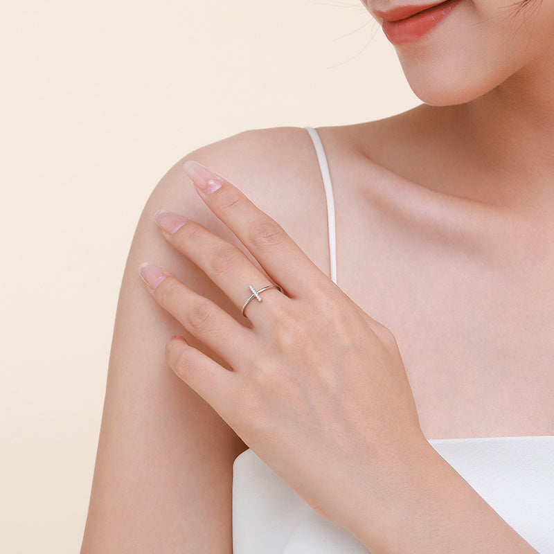 Slim vertical sparkle bar ring worn on a woman's finger