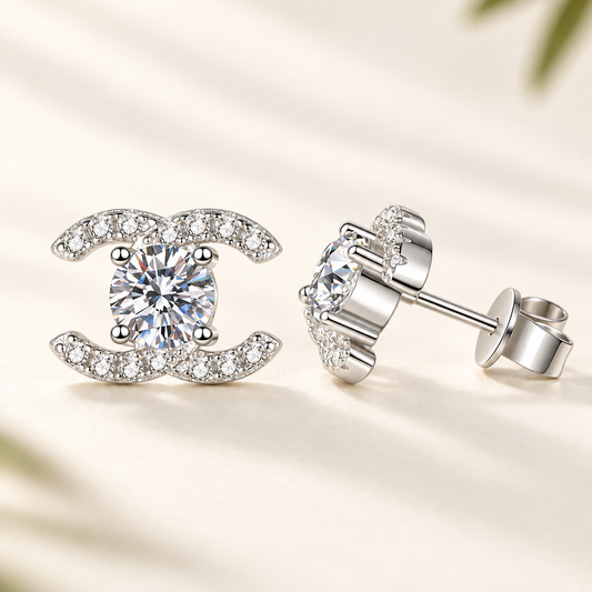 Celeste double-C moissanite stud earrings close-up: 5 mm round moissanite studs framed by double-C curves, Dubai