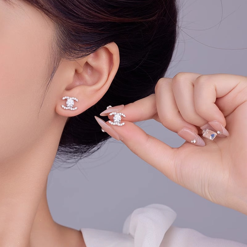 Celeste double-C moissanite stud earrings, view 3: 5 mm round moissanite studs framed by double-C curves, Dubai