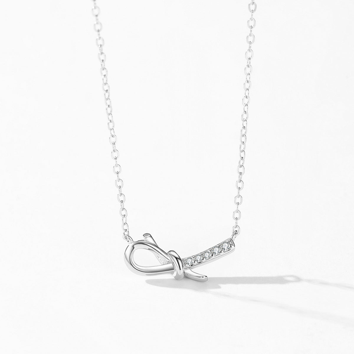 Elina bow CZ necklace & stud earrings set, view 4: sculpted bow pendant with matching bow studs, Dubai