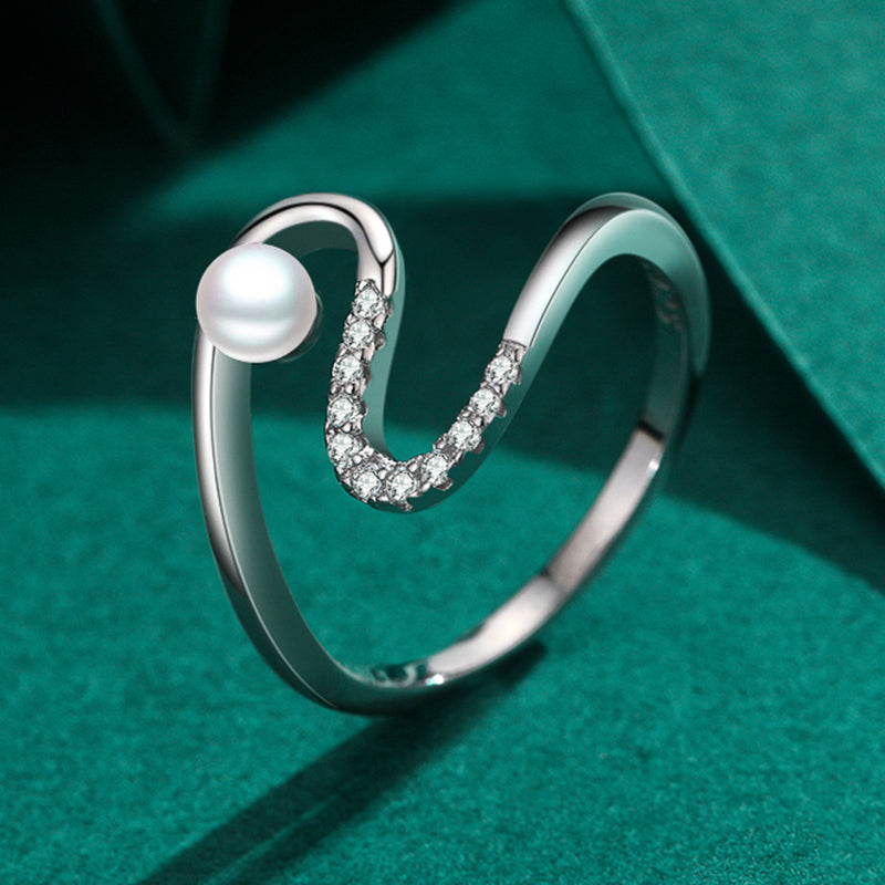 Gia pearl wave ring, view 4: petite pearl beside an open stone-set silver wave, 925 sterling silver, Dubai