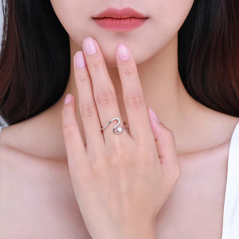 Gia pearl wave ring, view 3: petite pearl beside an open stone-set silver wave, 925 sterling silver, Dubai