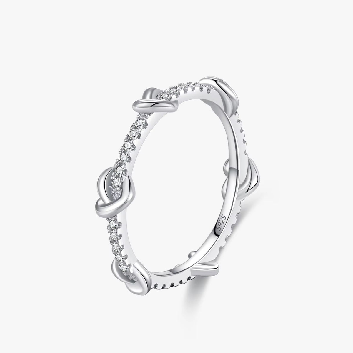 Mila heart knot CZ ring close-up: small polished hearts along a CZ-set band, 925 sterling silver, Dubai
