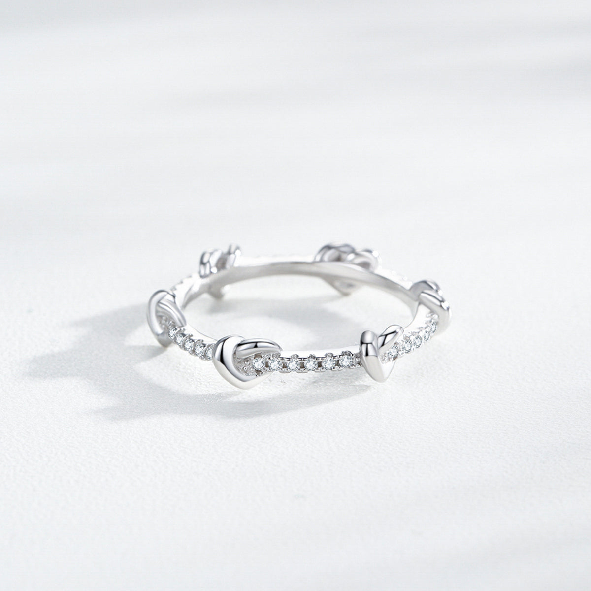 Mila heart knot CZ ring, view 4: small polished hearts along a CZ-set band, 925 sterling silver, Dubai