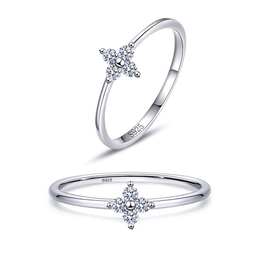 Noura four-petal flower CZ ring close-up: four pear-shaped CZ petals around a polished centre, 925 sterling silver, Dubai