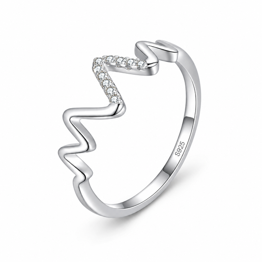 Nura heartbeat pavé ring close-up: delicate heartbeat wave with clear pavé, 925 sterling silver, Dubai