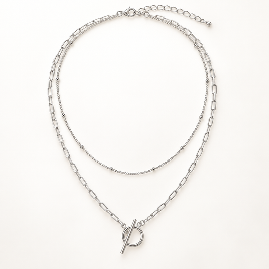Vera bead & paperclip layered toggle necklace close-up: bead-station chain layered with paperclip chain and toggle, Dubai
