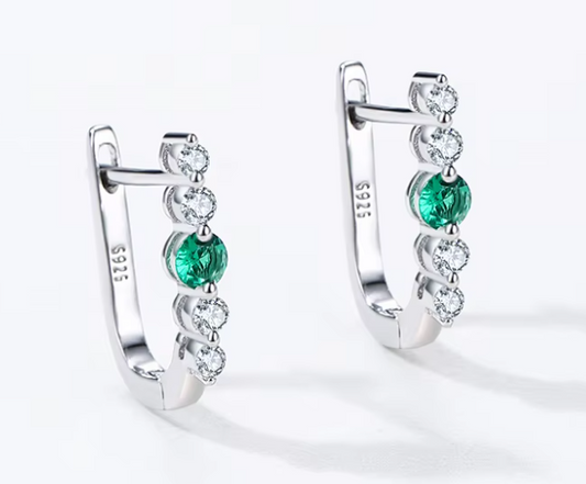 Verdure green stone huggie earrings close-up: huggies with a rich green CZ centre, 925 sterling silver, Dubai
