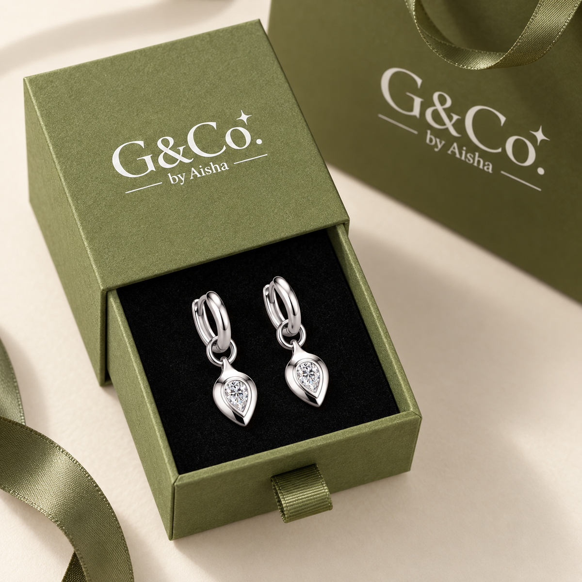 Zoe pear moissanite huggie drop earrings, view 5: 4 x 6 mm pear moissanite drop on a polished huggie, Dubai